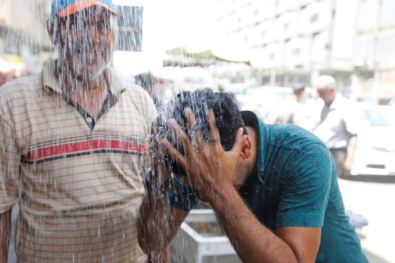 A man washes his face to cool off from the scorching summer heat in Baghdad, July 20, 2016. REUTERS/Khalid al Mousily