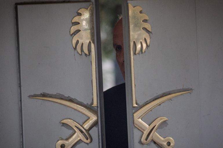 A security guard looks out the front door of Saudi Arabia consulate