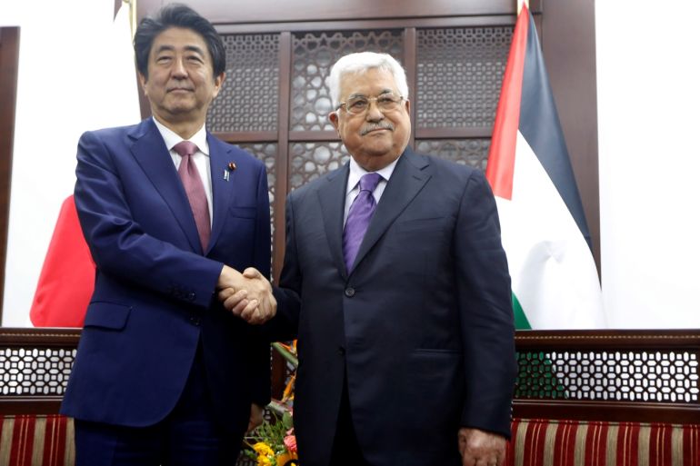 Palestinian President Mahmoud Abbas shakes hands with Japan's Prime Minister Shinzo Abe in Ramallah, in the occupied West Bank May 1, 2018. Majdi Mohammed/Pool via REUTERS