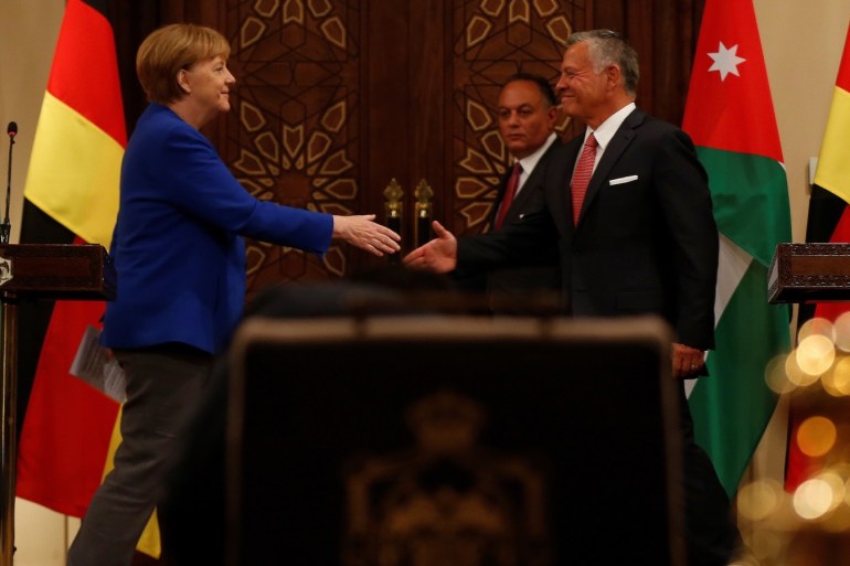 German Chancellor Angela Merkel shakes hands with Jordan King Abdullah