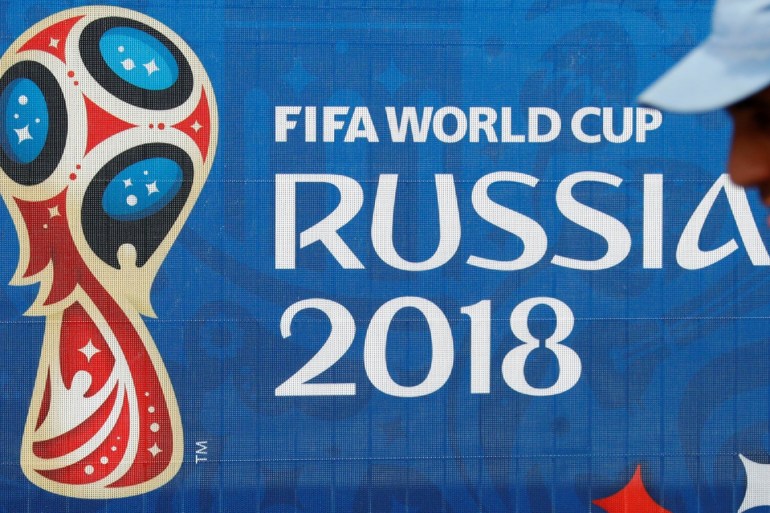 Soccer Football - FIFA World Cup - Saint Petersburg Stadium, St. Petersburg, Russia - June 11, 2018. A man is seen next to the FIFA World Cup logo at the stadium. REUTERS/Fabrizio Bensch