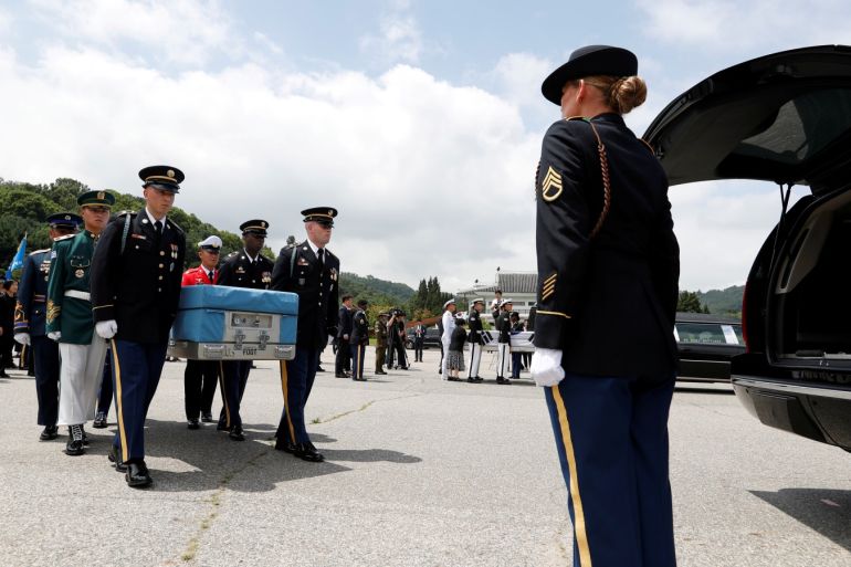 honor guards carry the remains of the United Nations Command