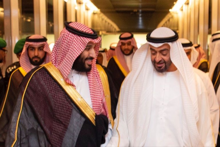 Saudi Crown Prince Mohammed bin Salman walks with Abu Dhab Crown Prince Sheikh Mohammed bin Zayed al-Nahyan