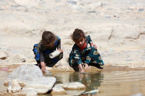 Displaced Yemeni girls are seen near a watercourse at a refugee camp located between Marib and Sanaa, Yemen March 29, 2018. REUTERS/Ali Owidha