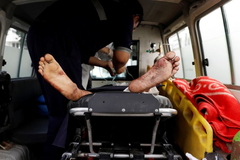 ATTENTION EDITORS - VISUAL COVERAGE OF SCENES OF INJURY OR DEATH An injured man receives treatment inside an ambulance at a hospital after a blast in Kabul, Afghanistan August 15, 2018. REUTERS/Mohammad Ismail