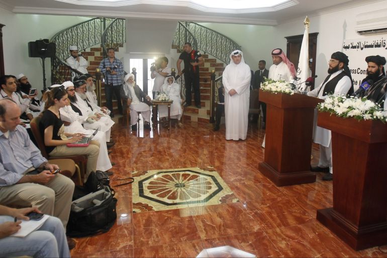 Muhammad Naeem (2nd R), a spokesman for the Office of the Taliban of Afghanistan, stands next to a translator speaking during the opening of the Taliban Afghanistan Political Office in Doha June 18, 2013. The Afghan Taliban opened the office in Qatar on Tuesday to help restart talks on ending the 12-year-old war, saying it wanted a political solution that would bring about a just government and end foreign occupation. Taliban representative Naeem told a news conference