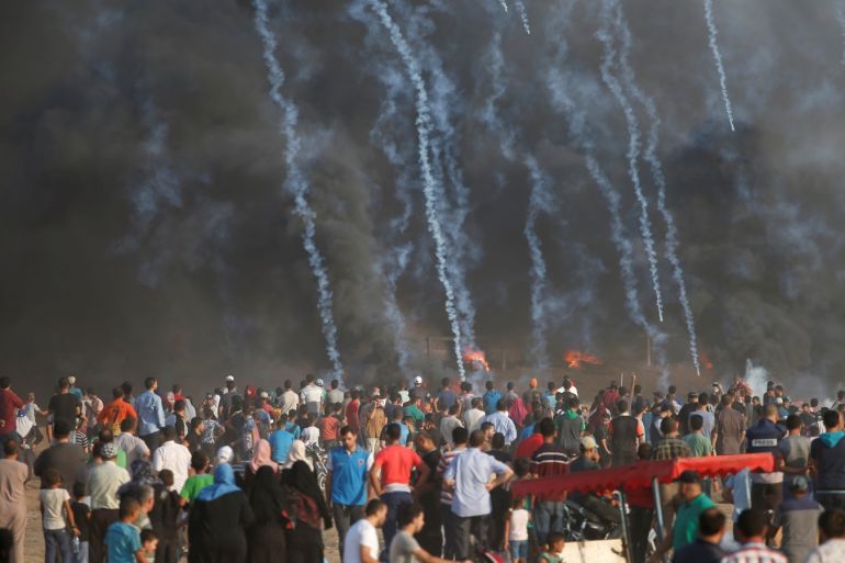 Tear gas canisters are fired by Israeli troops towards Palestinian demonstrators during a protest demanding the right to return to their homeland at the Israel-Gaza border, east of Gaza City August 3, 2018. REUTERS/Mohammed Salem