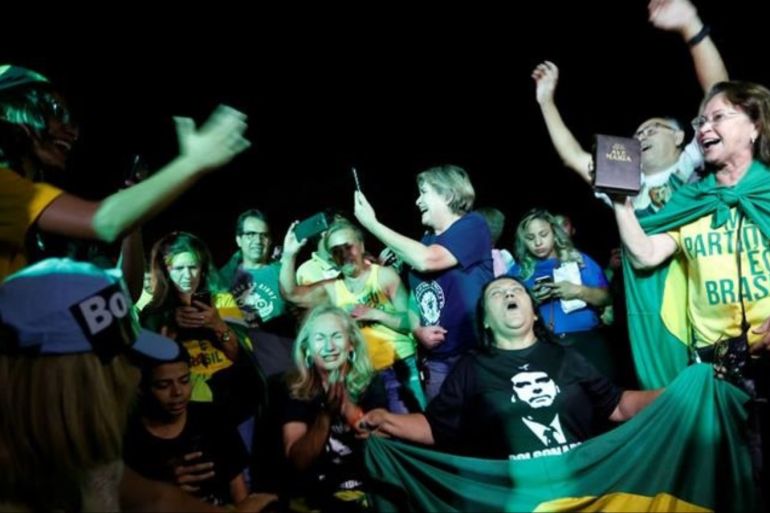 Supporters of Jair Bolsonaro celebrate in Brasilia on Sunday night