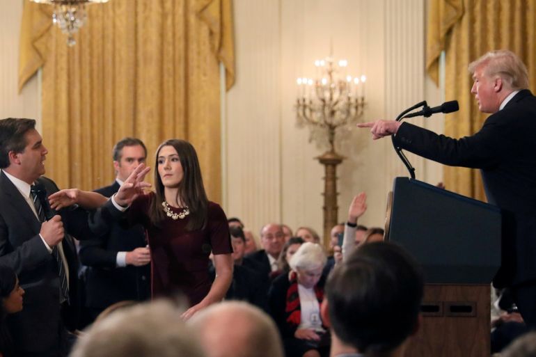 FILE PHOTO: A White House staff member reaches for the microphone held by CNN's Jim Acosta as he questions U.S. President Donald Trump during a news conference following Tuesday's midterm U.S. congressional elections at the White House in Washington, U.S., November 7, 2018. REUTERS/Jonathan Ernst/File Photo