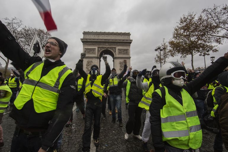 PARIS, FRANCE - DECEMBER 01: Protesters yell during a 'Yellow Vest' demonstration near the Arc de Triomphe on December 1, 2018 in Paris, France. The third 'Yellow Vest' (gilets jaunes) rally in Paris over increased fuel taxes and leadership in the government today caused over 150 arrests in the city with reports of injuries to protesters and security forces from violence that irrupted from the clashes. (Photo by Veronique de Viguerie/Getty Images)