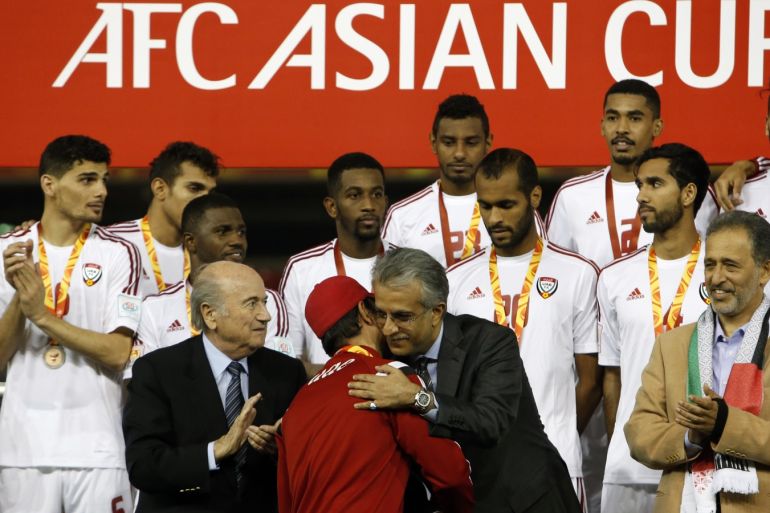 UAE's coach Mahdi Ali Hassan (C) is congratulated as his players look on on the podium following their Asian Cup third-place playoff soccer match win over Iraq at the Newcastle Stadium in Newcastle January 30, 2015. REUTERS/Edgar Su (AUSTRALIA - Tags: SOCCER SPORT)