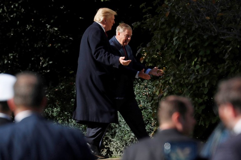 U.S. President Donald Trump walks with Sen. Lindsey Graham (R-SC) upon Trump's return from the Supreme Court to the White House in Washington, U.S., November 8, 2018. REUTERS/Kevin Lamarque