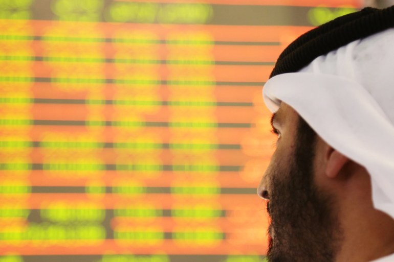 An investor looks at the screen at the Dubai International Financial Market in Dubai, UAE February 7, 2018. REUTERS/Satish Kumar