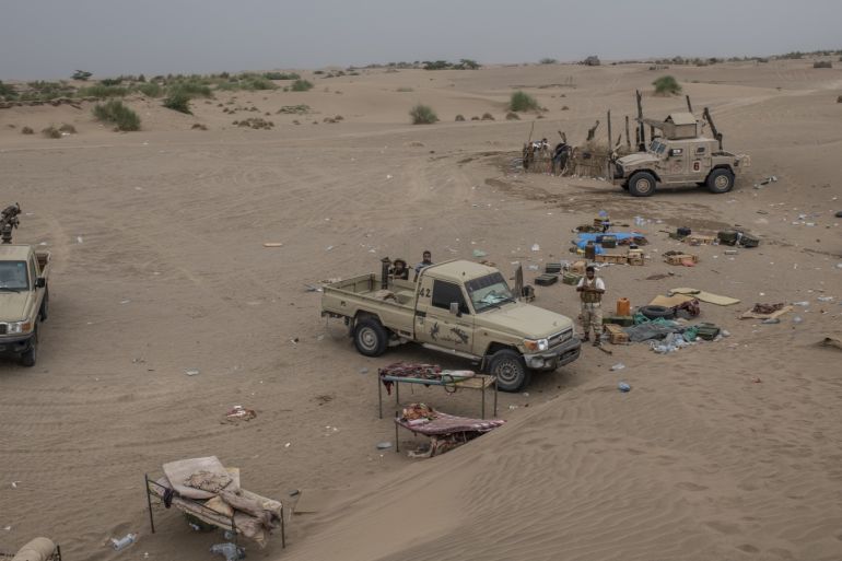 HODEIDAH, YEMEN - SEPTEMBER 20: Tahami Resistance fighters, a militia aligned with Yemen's Saudi-led coalition-backed government, look for Houthi rebel positions on a frontline east of the city on September 20, 2018 in Hodeidah, Yemen. A coalition military campaign has moved west along Yemen's coast toward Hodeidah, where increasingly bloody battles have killed hundreds since June, putting the country's fragile food supply at risk. (Photo by Andrew Renneisen/Getty Images)