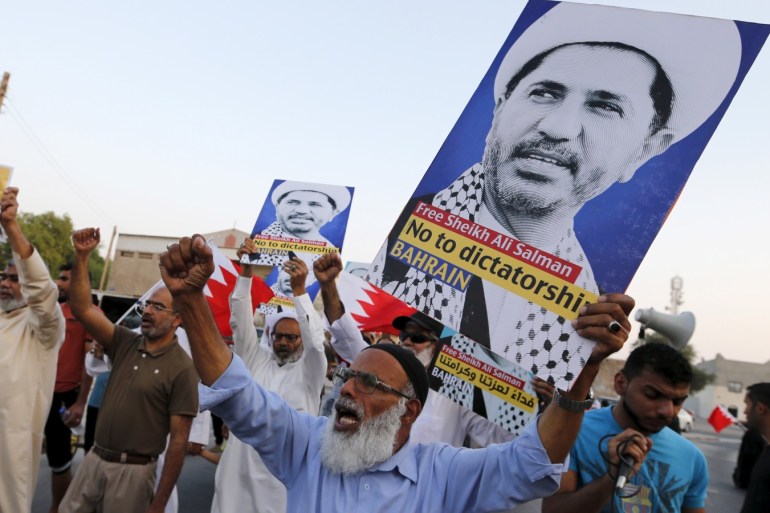 Protesters hold placards with photos of opposition leader and head of Al Wefaq party, Ali Salman, during a protest in the village of Karzakan south of Manama, Bahrain, October 3, 2015. REUTERS/Hamad I Mohammed