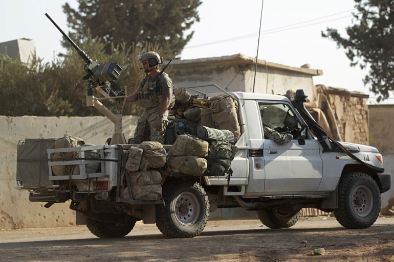U.S soldiers ride a military vehicle in al-Kherbeh village, northern Aleppo province, Syria October 24, 2016. REUTERS/Khalil Ashawi