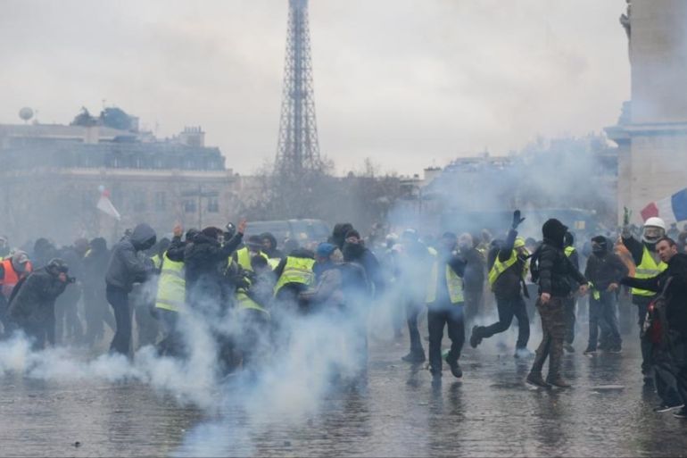 Yellow vest demonstration in Paris- - PARIS, FRANCE - JANUARY 12: French riot police use tear gas and water cannon to disperse yellow vests protesters during their protest in Paris, France on January 12, 2019.