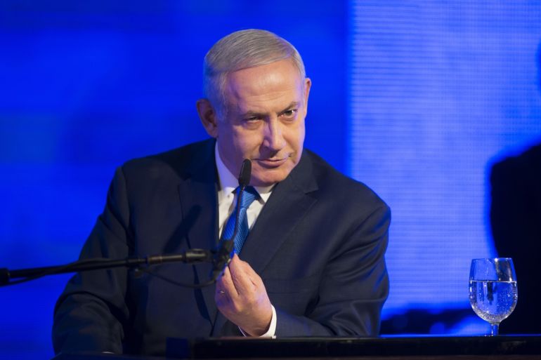 RAMAT GAN, ISRAEL - DECEMBER 02: (ISRAEL OUT) Israeli Prime Minister Benjamin Netanyahu gestures while delivering a speech before lighting a stylised-menorah during the start of Hanukkah, the Jewish festival of lights on December 2, 2018 in Ramat Gan, Israel. Earlier today, police and Israel Securities Authority recommended indicting Netanyahu and his wife, Sara, for bribery and other corruption charges. (Photo by Lior Mizrahi/Getty Images)