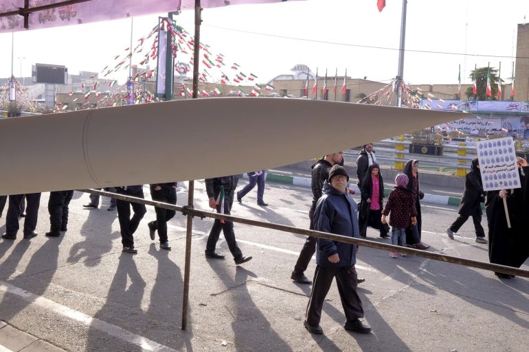 FILE PHOTO: People walk near an Iranian-made missile during a ceremony marking the 37th anniversary of the Islamic Revolution, in Tehran February 11, 2016. REUTERS/Raheb Homavandi/File Photo