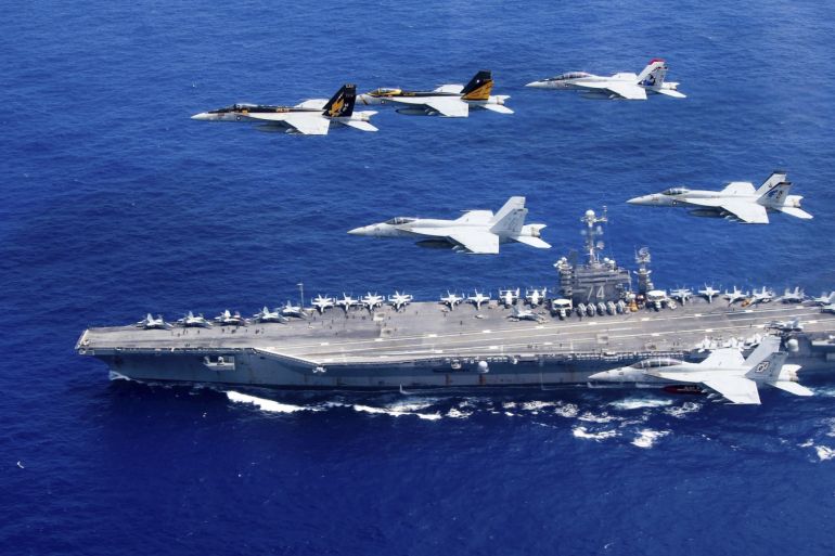 A combined formation of aircraft from Carrier Air Wing (CVW) 5 and Carrier Air Wing (CVW) 9 pass in formation above the Nimitz-class aircraft carrier USS John C. Stennis (CVN 74) in the Philippine Sea on June 18, 2016. Courtesy Steve Smith/U.S. Navy/Handout via REUTERS ATTENTION EDITORS - THIS IMAGE WAS PROVIDED BY A THIRD PARTY. EDITORIAL USE ONLY