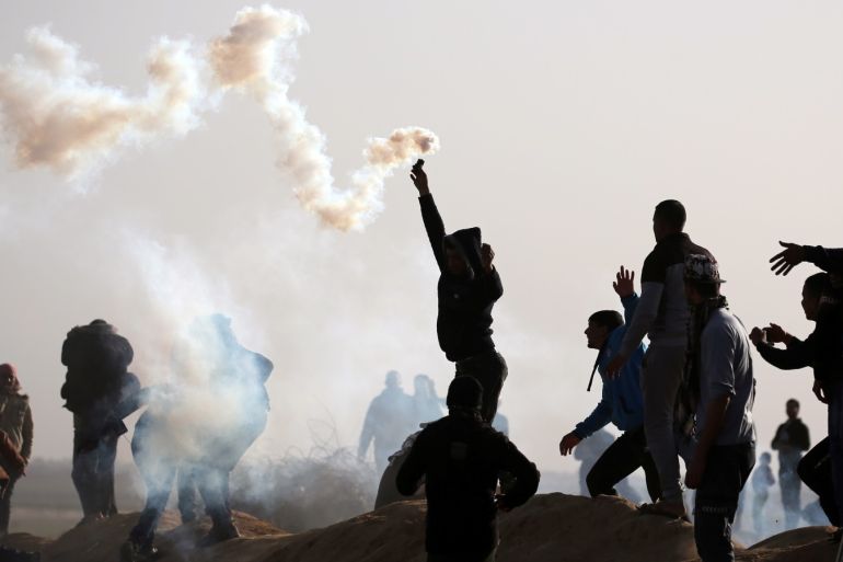 A Palestinian demonstrator holds a tear gas canister fired by Israeli forces during a protest at the Israel-Gaza border fence, in the southern Gaza Strip February 1, 2019. REUTERS/Ibraheem Abu Mustafa