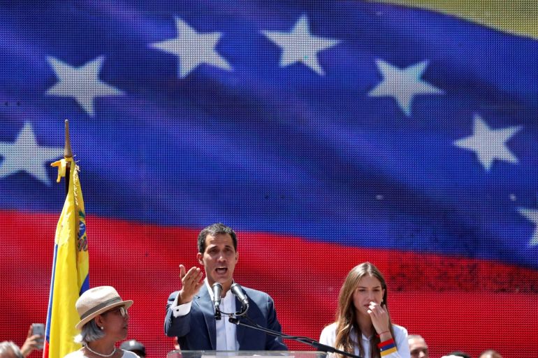 Venezuelan opposition leader Juan Guaido, who many nations have recognized as the country's rightful interim ruler, speaks next to his mother Norka Marquez and his wife Fabiana Rosales, as he attends a rally to commemorate the Day of the Youth and to protest against Venezuelan President Nicolas Maduro's government in Caracas, Venezuela February 12, 2019. REUTERS/Carlos Garcia Rawlins