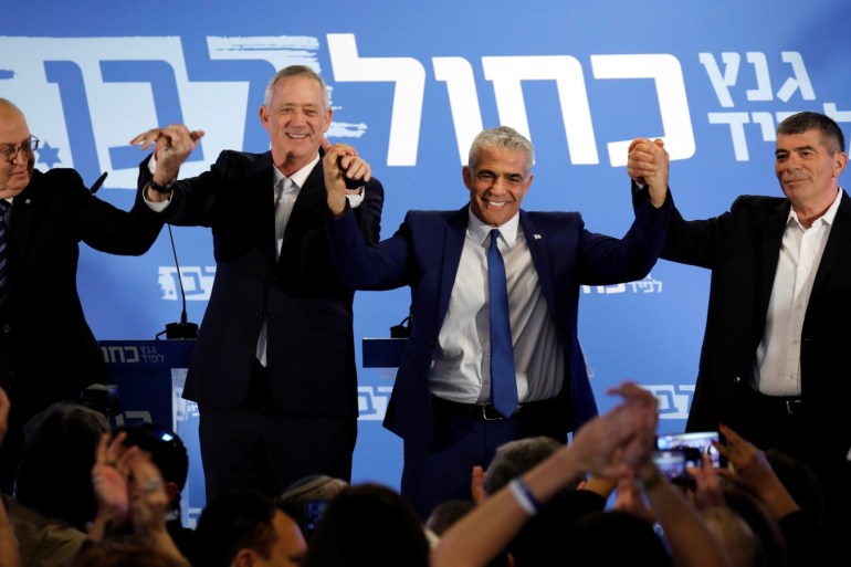 Benny Gantz, head of Resilience party and Yair Lapid, head of Yesh Atid, Moshe Yaalon and Gaby Ashkenazy react at the end of a news conference to announce the formation of their joint party, following an alliance between their parties, in Tel Aviv, Israel February 21, 2019. REUTERS/Amir Cohen