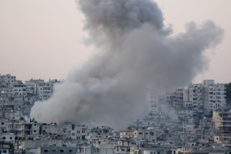 Assad regime hits Syria's Idlib- - IDLIB, SYRIA - MAY 14 : Smoke rises after an attack by Assad regime forces, before people break their fast on marketplace of Jisr al-Shughour district located inside northern Syria’s de-escalation zones, in Syria’s northwestern Idlib province on May 14, 2019. Five civilians were killed and 20 other injured in attacks.