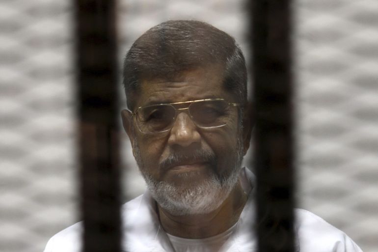 Ousted Egyptian President Mohamed Mursi is seen behind bars during his trial at a court in Cairo May 8, 2014. REUTERS/Stringer (EGYPT - Tags: POLITICS CRIME LAW HEADSHOT)