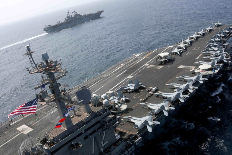 The Nimitz-class aircraft carrier USS Abraham Lincoln (CVN 72) and the Wasp-class Amphibious Assault Ship USS Kearsarge (LHD 3) sail alongside, as the Abraham Lincoln Carrier Strike Group (ABECSG) and Kearsarge Amphibious Ready Group (KSGARG) conduct joint operations, in the U.S. 5th Fleet area of operations in the Arabian Sea, May 17, 2019. Picture taken May 17, 2019. Mass Communication Specialist 1st Class Brian M. Wilbur/U.S. Navy/Handout via REUTERS ATTENTION EDITOR