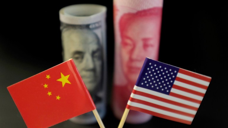 U.S. and Chinese flags are seen in front of a U.S. dollar banknote featuring American founding father Benjamin Franklin and a China's yuan banknote featuring late Chinese chairman Mao Zedong in this illustration picture taken May 20, 2019. Picture taken May 20, 2019. REUTERS/Jason Lee/Illustration