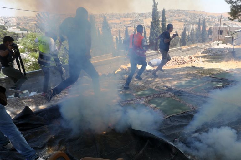 Reactions to Israel's demolition of houses in Jerusalem- - JERUSALEM - AUGUST 02 : Israeli forces launch tear gas as they intervene in a protest by Palestinians against the demolition of some of Palestinian houses by Israel in Sur Baher town on the southeastern outskirts of East Jerusalem on August 02, 2019.