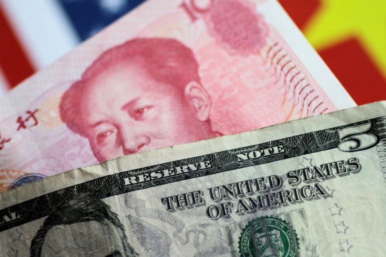 U.S. Dollar and China Yuan notes are seen in this picture illustration June 2, 2017. REUTERS/Thomas White/Illustration
