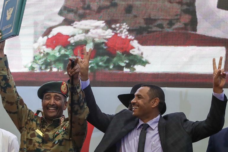 Signing ceremony of Constitutional Declaration in Sudan- - KHARTOUM, SUDAN - JULY 17 : Sudanese General and Vice President of Sudanese Transitional Military Council, Mohamed Hamdan Dagalo and Sudan's Forces of Freedom and Change coalition's leader Ahmad al-Rabiah greet after signing an agreement in Khartoum on July 17, 2019. Sudan's ruling military council and a coalition of opposition groups on Wednesday signed a political deal that paves the way for the handover of