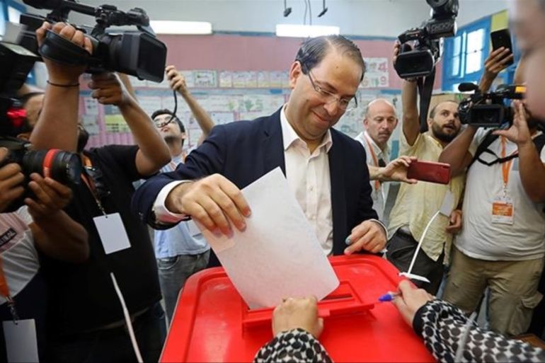 Tunisia's prime minister and presidential candidate Youssef Chahed casts his vote in a polling st
