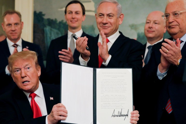 U.S. President Donald Trump holds a proclamation recognizing Israel's sovereignty over the Golan Heights as he is applauded by Israel's Prime Minister Benjamin Netanyahu and others during a ceremony in the Diplomatic Reception Room at the White House in Washington, U.S., March 25, 2019. REUTERS/Carlos Barria TPX IMAGES OF THE DAY