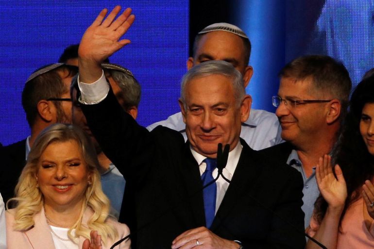Israeli Prime Minister Benjamin Netanyahu stands next to his wife Sara as he waves to supporters at his Likud party headquarters following the announcement of exit polls during Israel's parliamentary election in Tel Aviv, Israel September 18, 2019. REUTERS/Ronen Zvulun