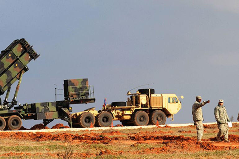 US soldiers stand near a Patriot missile system at a Turkish military base in Gaziantep on February 5, 2013. The United States, Germany and the Netherlands committed to send two missile batteries each and up to 400 soldiers to operate them after Ankara asked for help to bolster its air defences against possible missile attack from Syria. AFP PHOTO / BULENT KILIC