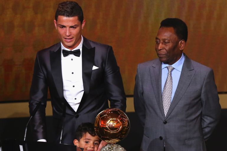 ZURICH, SWITZERLAND - JANUARY 13: Crisitano Ronaldo (L) of Portugal withh his son Cristiano Ronaldo Jr receives the FIFA Ballon d'Or 2013 trophy at the Kongresshalle on January 13, 2014 in Zurich, Switzerland. (Photo by Martin Rose/Bongarts/Getty Images)