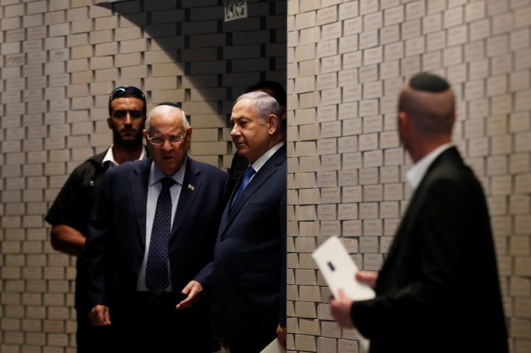 Israeli Prime Minister Benjamin Netanyahu stands next to Israeli President Reuven Rivlin during a memorial ceremony for Israeli soldiers killed in the 1973 Middle East War at Mount Herzl Military Cemetery in Jerusalem October 10, 2019. REUTERS/Ronen Zvulun