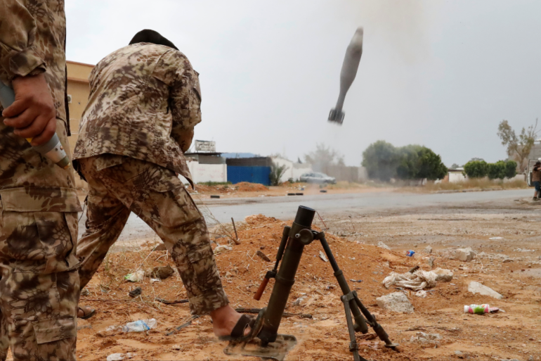 A fighter loyal to Libya's U.N.-backed government (GNA) fires a mortar during clashes with forces loyal to Khalifa Haftar on the outskirts of Tripoli, Libya May 25 2019 REUTERS Goran Tomasevic.png