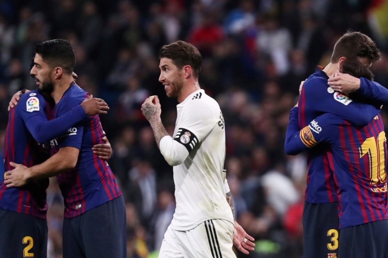Soccer Football - La Liga Santander - Real Madrid v FC Barcelona - Santiago Bernabeu, Madrid, Spain - March 2, 2019 FC Barcelona's Lionel Messi, Luis Suarez and Gerard Pique celebrate victory as Real Madrid's Sergio Ramos walks off REUTERS/Sergio Perez TPX IMAGES OF THE DAY