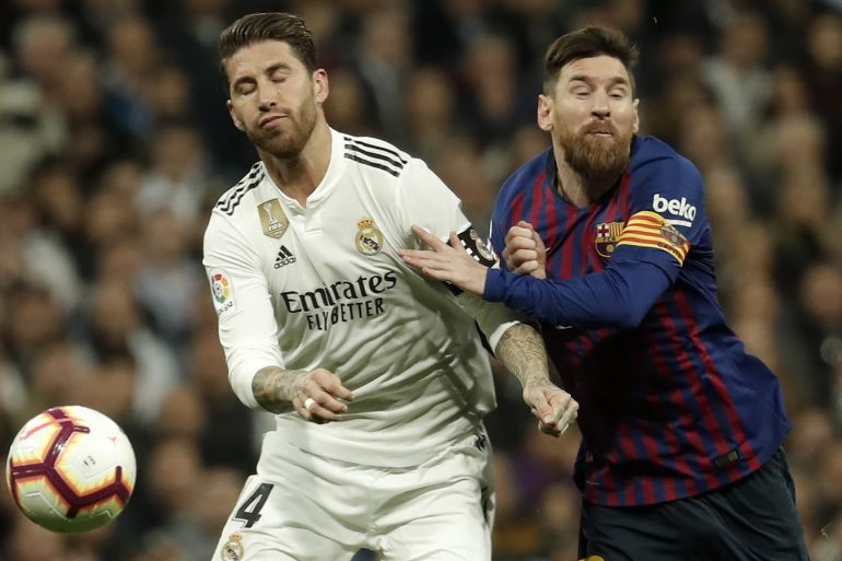 Real Madrid vs Barcelona: La Liga- - MADRID, SPAIN - MARCH 02: Lionel Messi (R) of Barcelona in action against Sergio Ramos (L) of Real Madrid during the La Liga week 26 soccer match between Real Madrid and Barcelona at Santiago Bernabeu Stadium in Madrid, Spain on March 02, 2019.