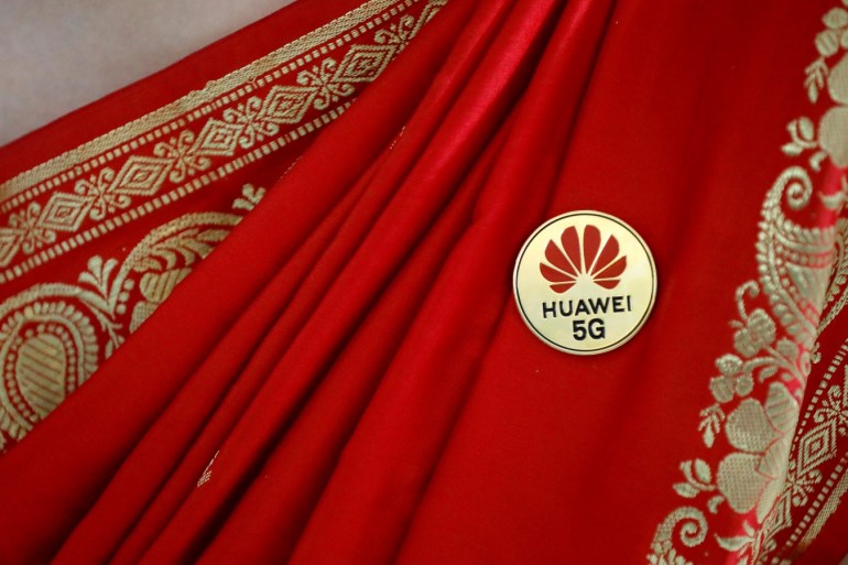 Huawei's logo is seen on a badge pinned on a saree of a lady at the India Mobile Congress in New Delhi, India, October 14, 2019. REUTERS/Anushree Fadnavis