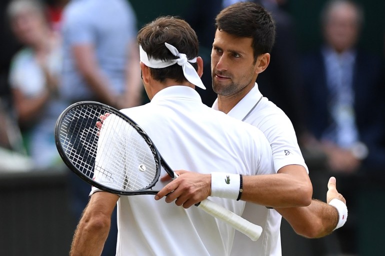 LONDON, ENGLAND - JULY 14: Novak Djokovic of Serbia embraces Roger Federer of Switzerland at the net following victory in his Men's Singles final during Day thirteen of The Championships - Wimbledon 2019 at All England Lawn Tennis and Croquet Club on July 14, 2019 in London, England. (Photo by Matthias Hangst/Getty Images)