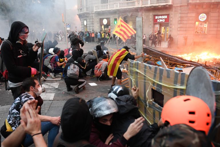Mass rally in Barcelona- - BARCELONA, SPAIN - OCTOBER 18: Protesters set up barricades during clashes near the Police headquarters in Barcelona, on October 18, 2019, on the day that separatists have called a general strike and a mass rally. - Spain's protest-hit northeast was gripped by a general strike today as thousands of