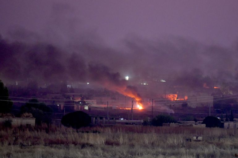 Operation Peace Spring starts in northern Syria- - SANLIURFA, TURKEY - OCTOBER 09: A photo taken from Turkey's Sanliurfa province, on October 09, 2019 shows smoke rises at the site of Ras al-Ayn city of Syria after terrorists burn tires to avoid being photographed by Turkish National Army's unmanned aerial vehicles (UAV) as Turkish troops along with the Syrian National Army begin Operation Peace Spring in northern Syria against PKK/YPG, Daesh terrorists.