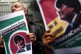 A man holds a sign during a demonstration in support of Bolivian President Evo Morales after he announced his resignation on Sunday, outside the Bolivian Embassy in Mexico City, Mexico, November 11, 2019. The sign reads,