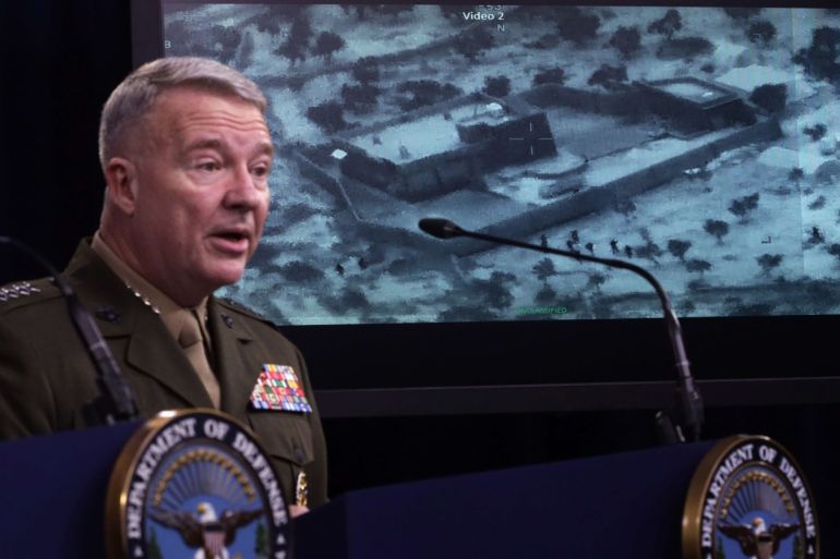 ARLINGTON, VIRGINIA - OCTOBER 30: U.S. Marine Corps Gen. Kenneth McKenzie, commander of U.S. Central Command, speaks as a picture of the operation targeting Abu Bakr al-Baghdadi is seen during a press briefing October 30, 2019 at the Pentagon in Arlington, Virginia. Gen. McKenzie and Hoffman spoke to the media to provide an update on the special operations raid that targeted former ISIS leader Abu Bakr al-Baghdadi in Idlib Province, Syria. Alex Wong/Getty Images/AFP==