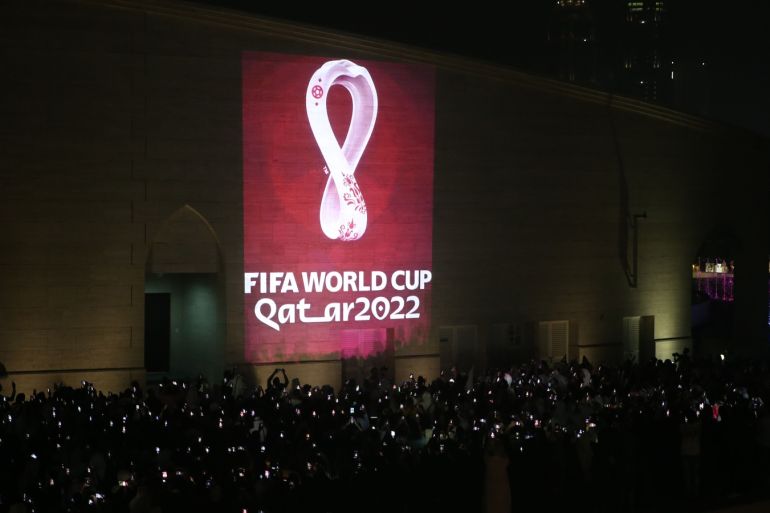 Qatar reveals 2022 World Cup logo- - DOHA, QATAR - SEPTEMBER 03: Hundreds of people take a photo as the official logo of the 'FIFA World Cup Qatar 2022' is reflected on a wall of the Amphitheatre in Doha, Qatar on September 03, 2019.